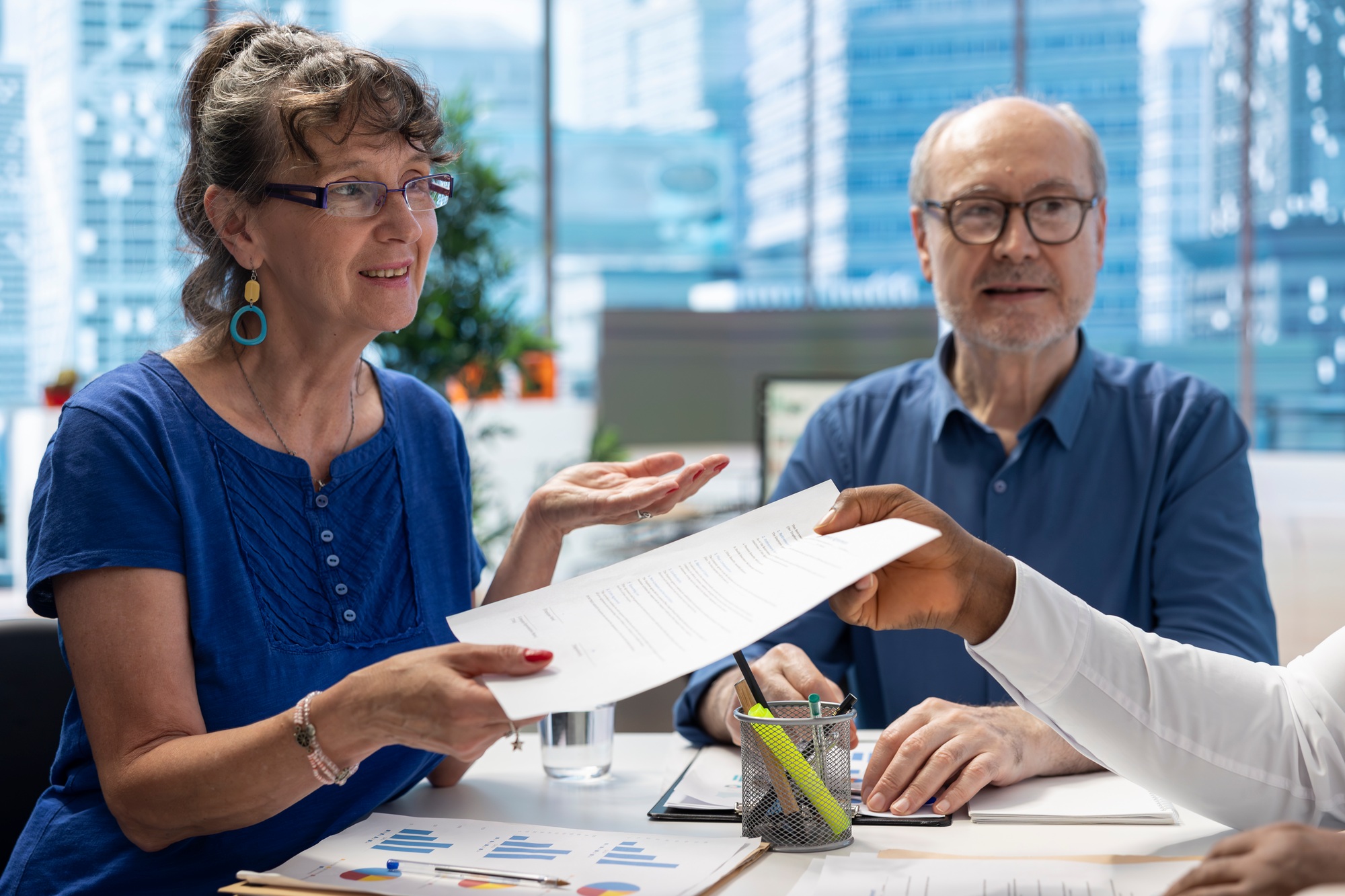 Financial advisor giving the retirement plan documents to old people